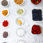 In this photo, you can see an açai bowl ingredients and toppings