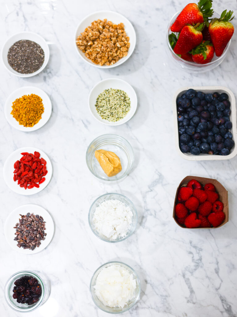 In this photo, you can see an açai bowl ingredients and toppings