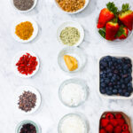 In this photo, you can see an açai bowl ingredients and toppings