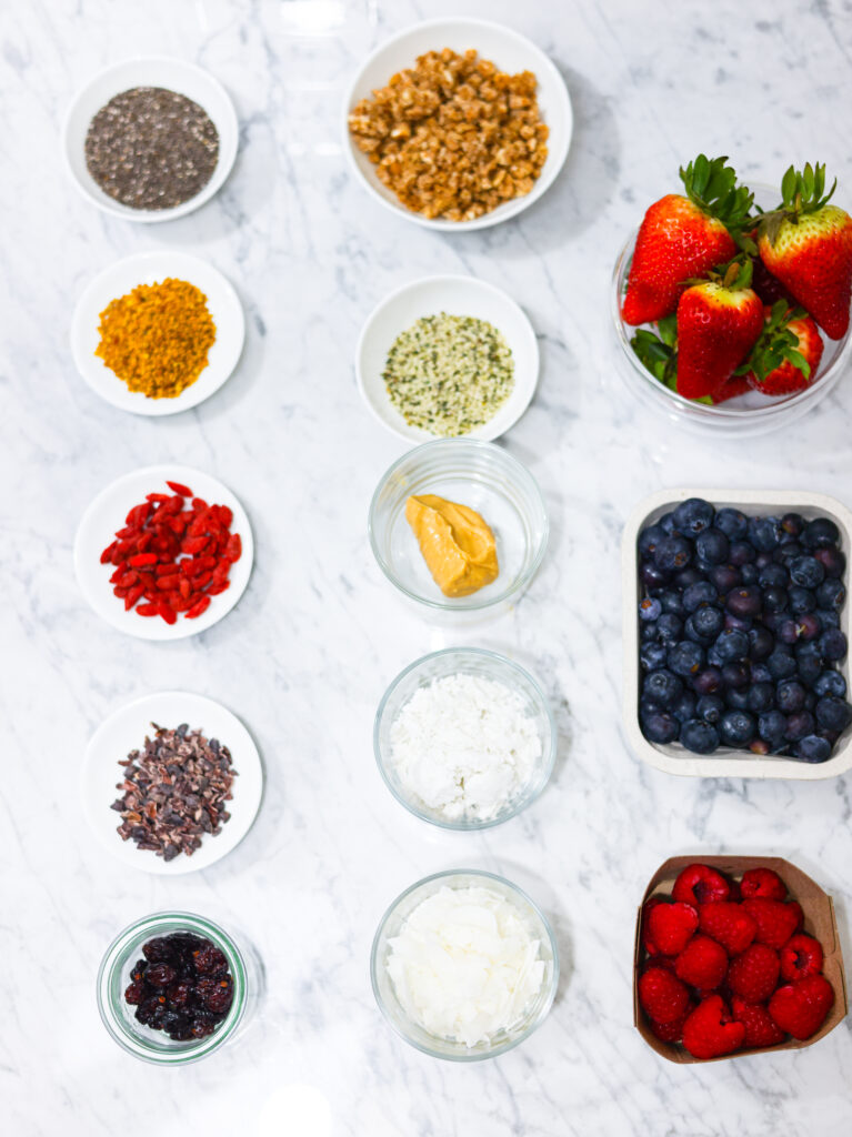 In this photo, you can see an açai bowl ingredients and toppings