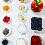 In this photo, you can see an açai bowl ingredients and toppings