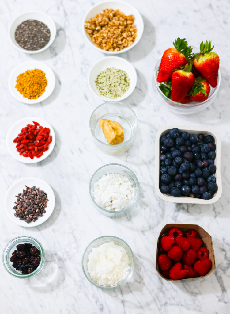 In this photo, you can see an açai bowl ingredients and toppings