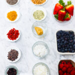 In this photo, you can see an açai bowl ingredients and toppings