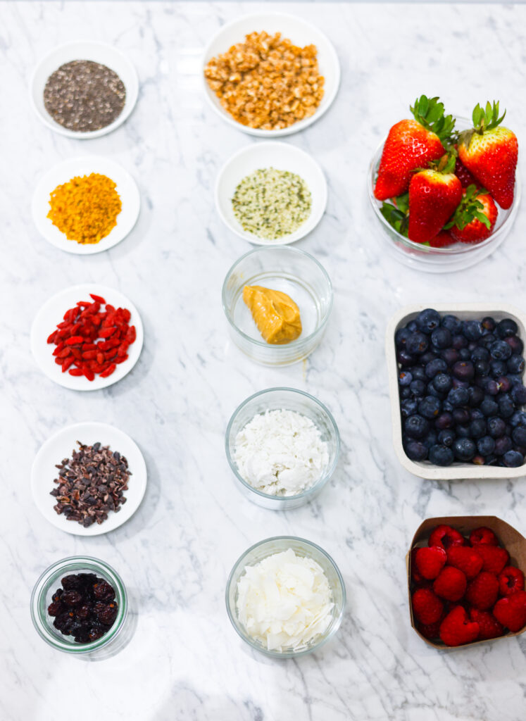 In this photo, you can see an açai bowl ingredients and toppings