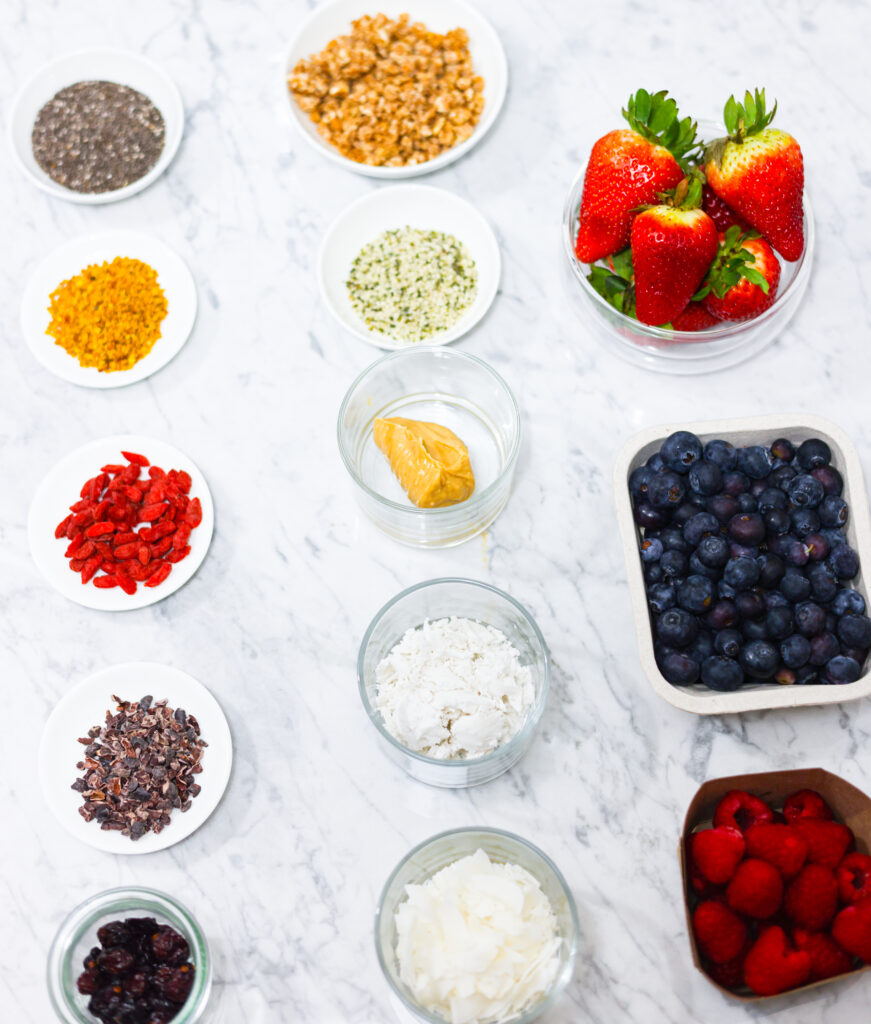 In this photo, you can see an açai bowl ingredients and toppings