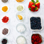 In this photo, you can see an açai bowl ingredients and toppings