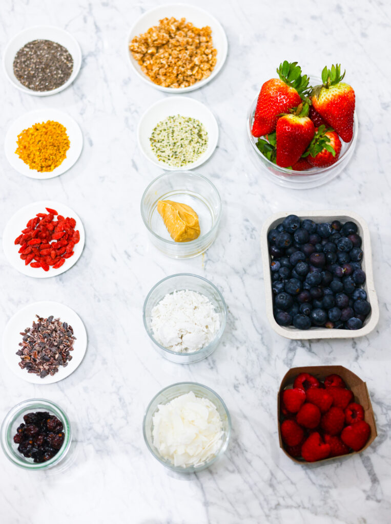 In this photo, you can see an açai bowl ingredients and toppings