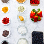 In this photo, you can see an açai bowl ingredients and toppings