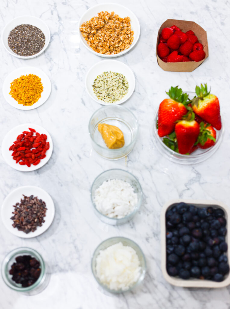 In this photo, you can see an açai bowl ingredients and toppings