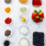 In this photo, you can see an açai bowl ingredients and toppings