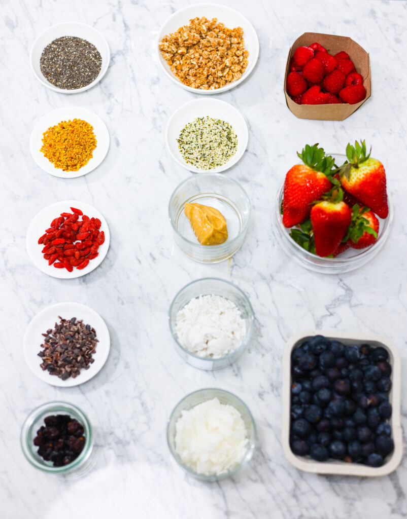 In this photo, you can see an açai bowl ingredients and toppings