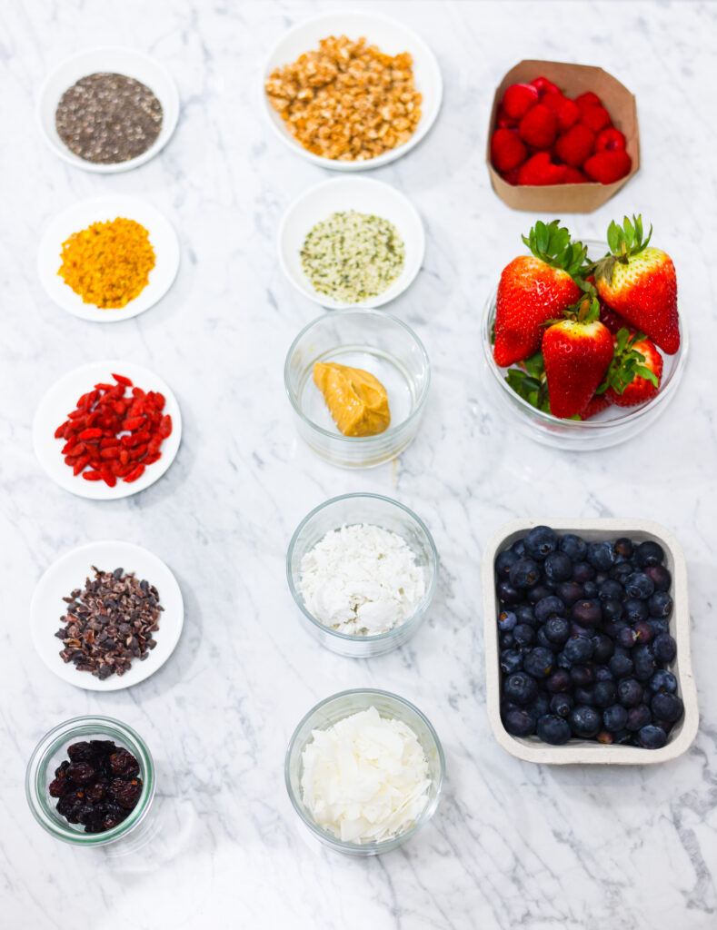 In this photo, you can see an açai bowl ingredients and toppings