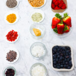 In this photo, you can see an açai bowl ingredients and toppings