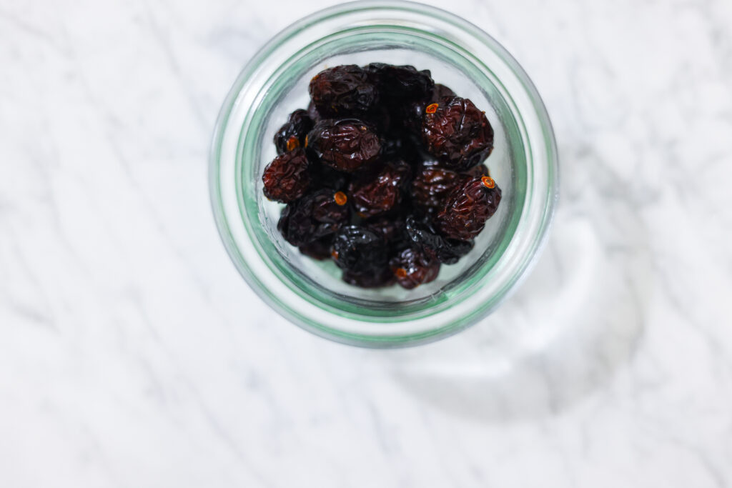 In this photo, you can see an açai bowl ingredients such as dried sour cherries