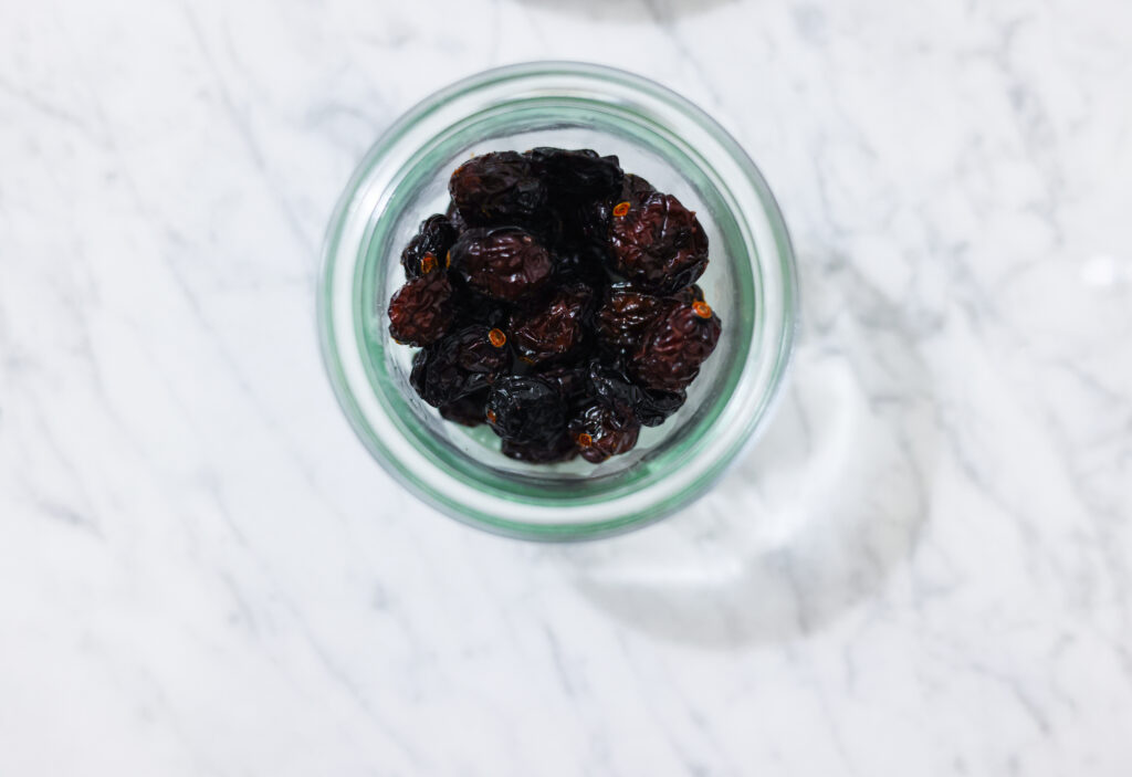 In this photo, you can see an açai bowl ingredients such as dried sour cherries