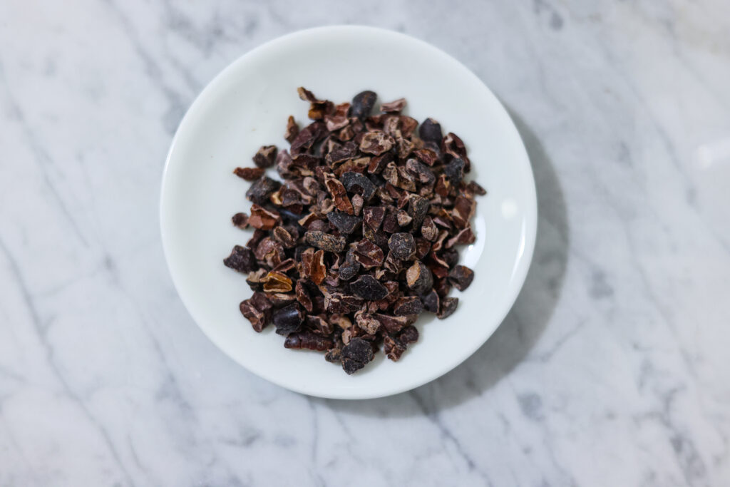 In this photo, you can see an açai bowl ingredients such as cocoa nibs