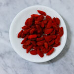 In this photo, you can see an açai bowl ingredients such as goji berries