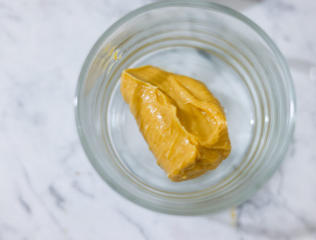 In this photo, you can see an açai bowl ingredients such as peanut butter