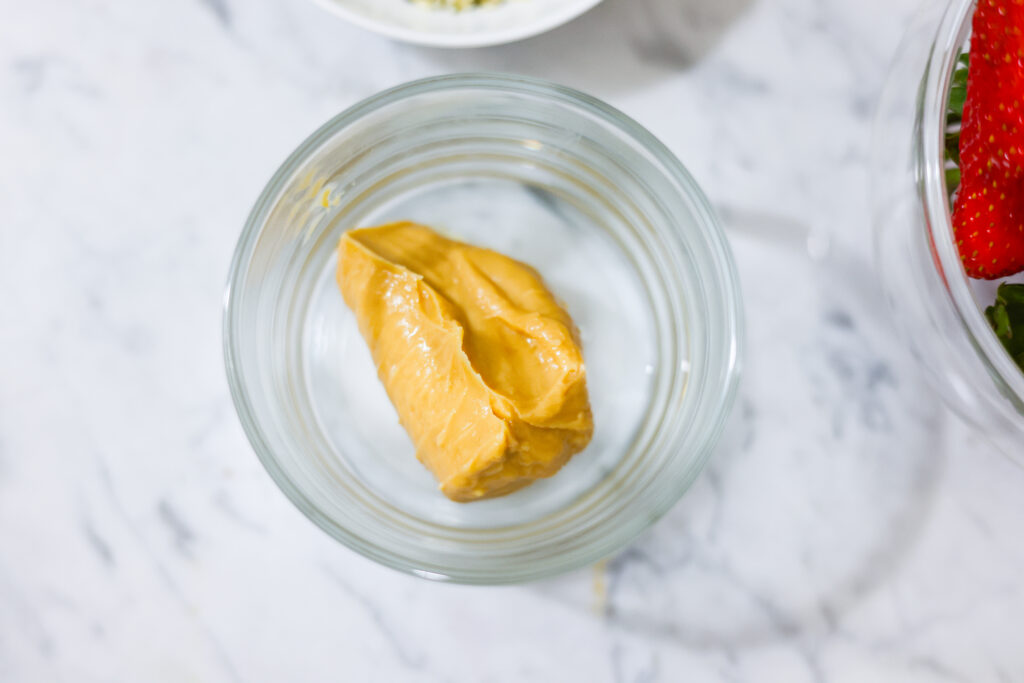 In this photo, you can see an açai bowl ingredients such as peanut butter