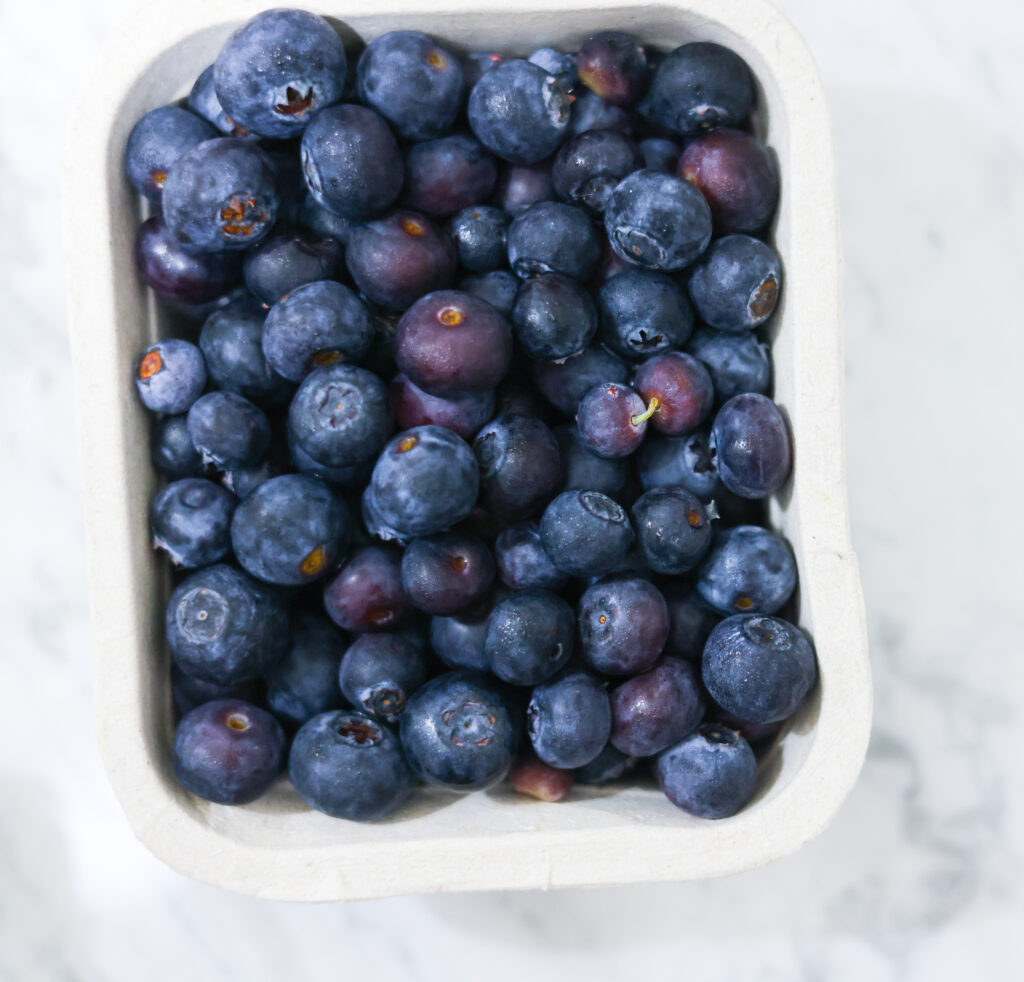 In this photo, you can see an açai bowl ingredients such as blueberries