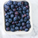 In this photo, you can see an açai bowl ingredients such as blueberries