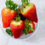 In this photo, you can see an açai bowl ingredients such as strawberries