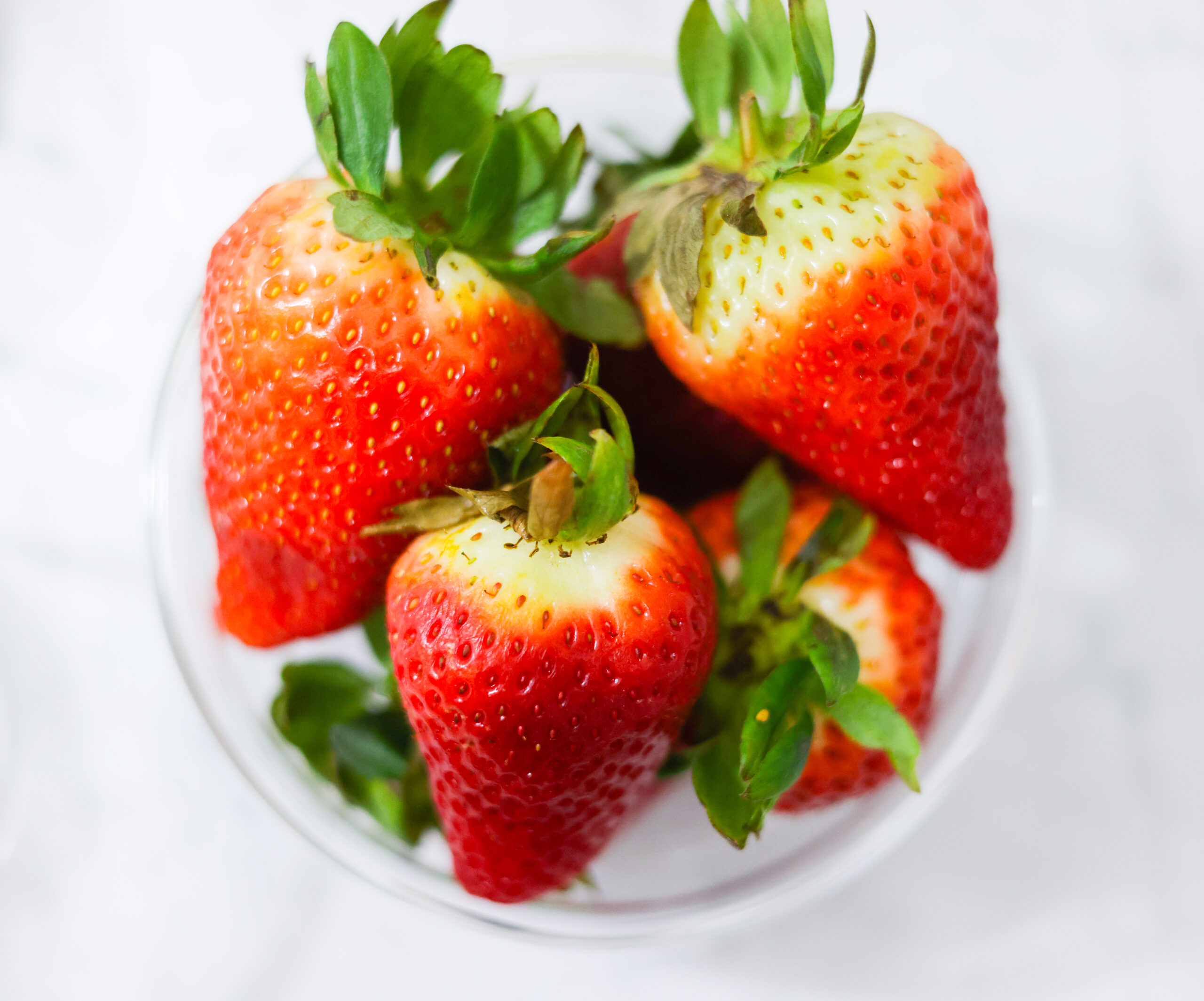 In this photo, you can see an açai bowl ingredients such as strawberries