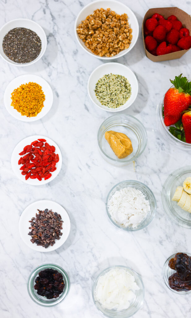 In this photo, you can see an açai bowl ingredients and toppings