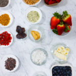 In this photo, you can see an açai bowl ingredients and toppings