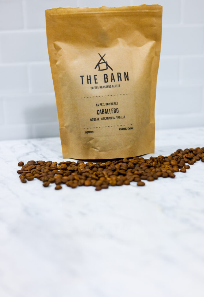 In this picture you can see the barn coffee beans. All objects are placed on white carrara marble and in the back are white metro tiles.