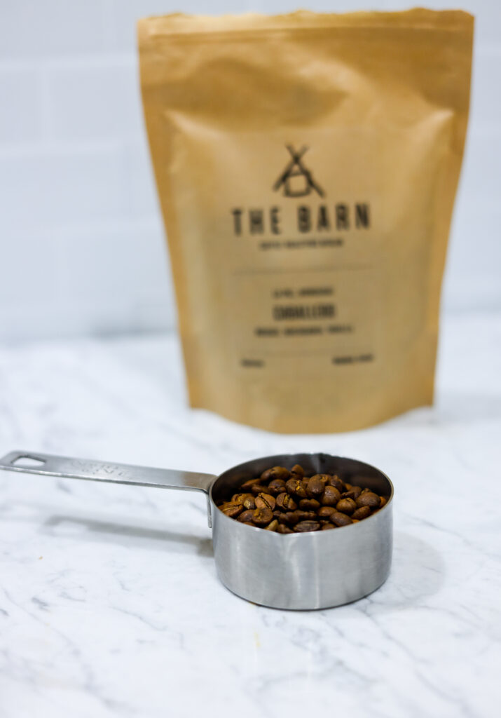 In this picture you can see the barn coffee beans. All objects are placed on white carrara marble and in the back are white metro tiles.