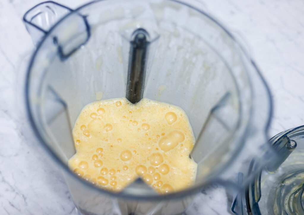 This picture shows a vitamix container with pumpkin spice latte dairy free drink