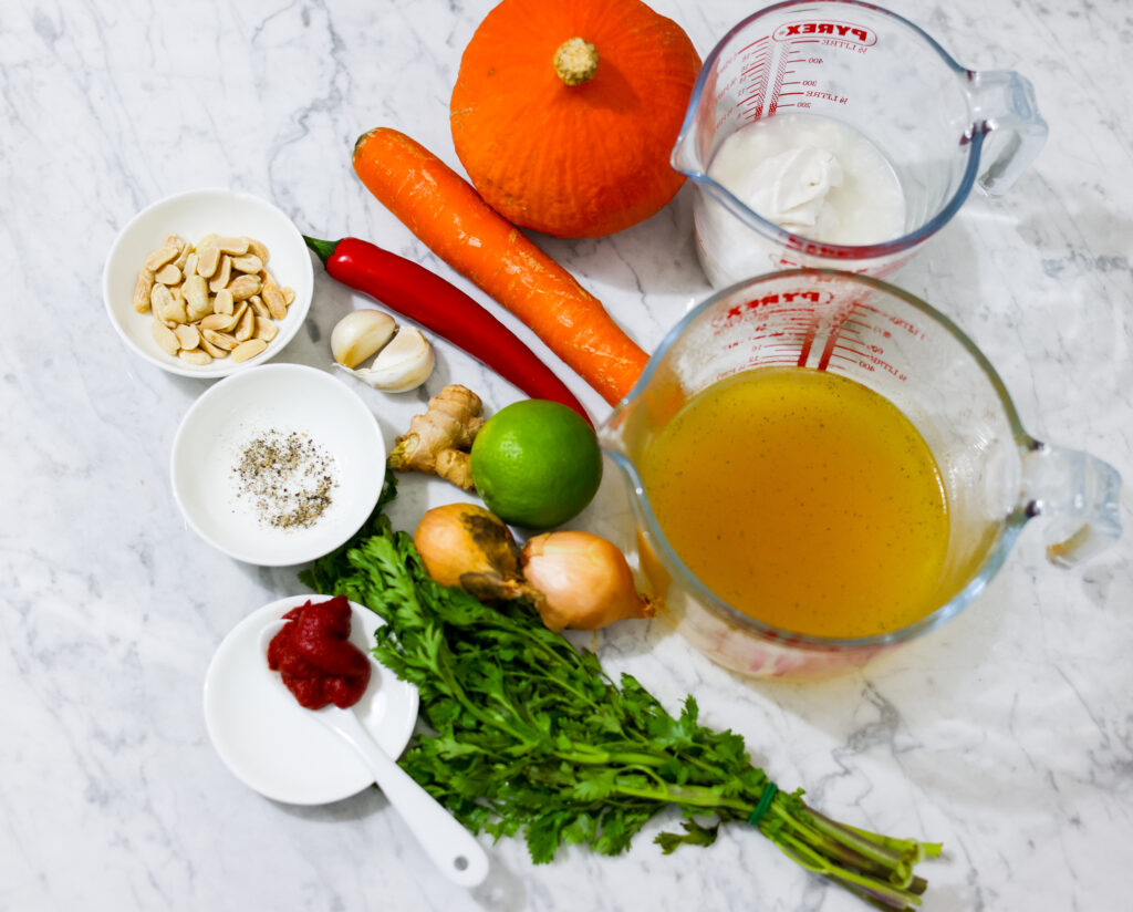 Thai Pumpkin Soup ingredients assembled on carrara marble