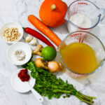 Thai Pumpkin Soup ingredients assembled on carrara marble