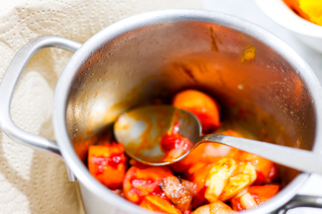 In this photo you can see Thai Pumpkin Soup ingredients assembled in a pot