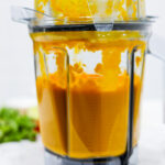 In this photo you can see a vitamix container with a puréed Vitamix Thai Pumpkin Soup in it.