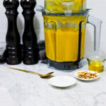 In this photo you can see a vitamix container with a puréed Vitamix Thai Pumpkin Soup in it.