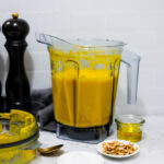 In this photo you can see a vitamix container with a puréed Vitamix Thai Pumpkin Soup in it.