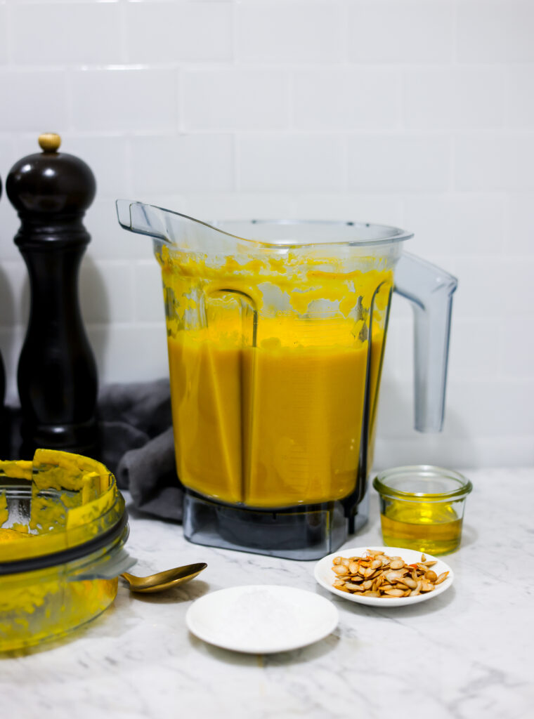 In this photo you can see a vitamix container with a puréed Vitamix Thai Pumpkin Soup in it.