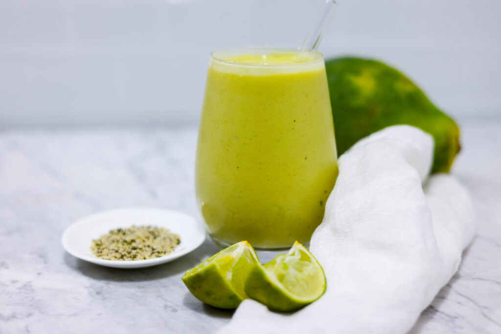 In this picture you can see the mango avocado smoothie. As decoration you can see an organic lime in front of the crystal glass.