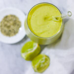 In this picture you can see the mango avocado smoothie. As decoration you can see an organic lime in front of the crystal glass.