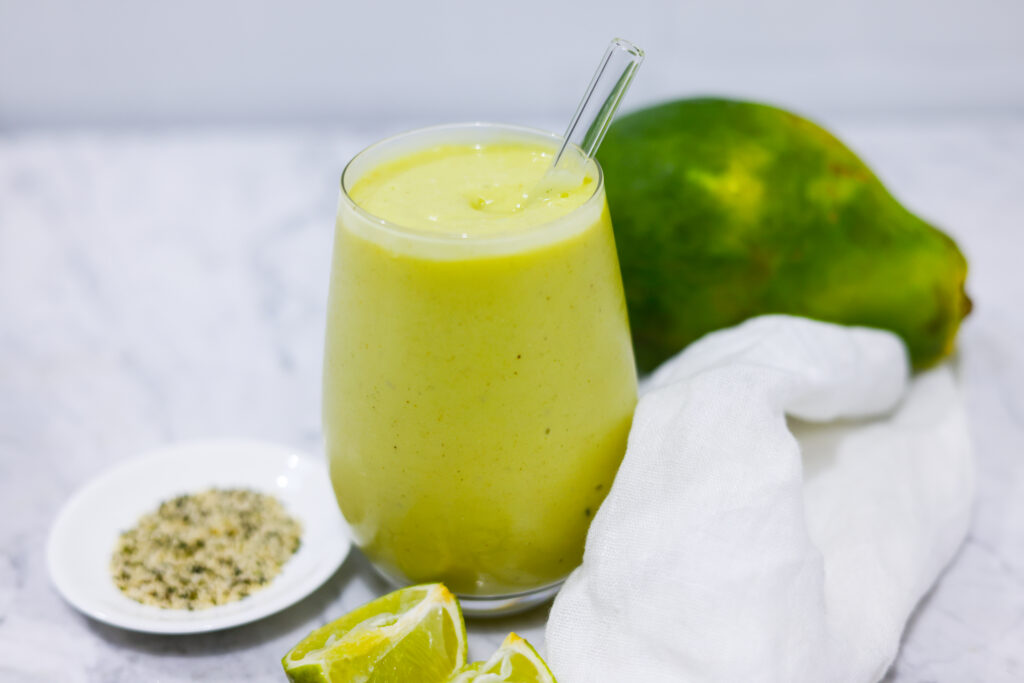 In this picture you can see the mango avocado smoothie. As decoration you can see an organic lime in front of the crystal glass.