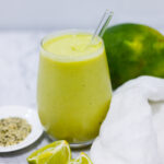 In this picture you can see the mango avocado smoothie. As decoration you can see an organic lime in front of the crystal glass.