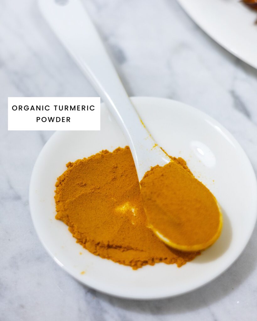 In this picture you can see one tablespoon of organic turmeric powder on a porcelain plate