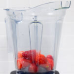 In this picture you can see a Vitamix container filled with organic strawberries which will be puréed