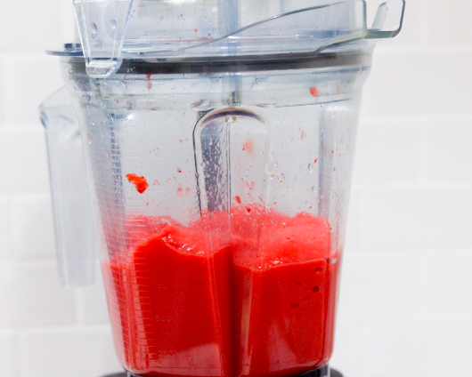 In this picture you can see The Vitamix container contains organic strawberries, which are puréed