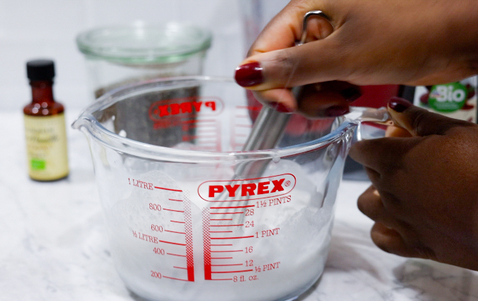 In this picture you can see a Pyrex glass filled with coconut milk and all the ingredients for Strawberry Chia Pudding