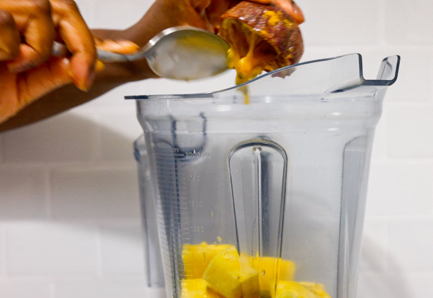 In this picture you can see the passion fruit is being added to the other ingredients in the Vitamix container