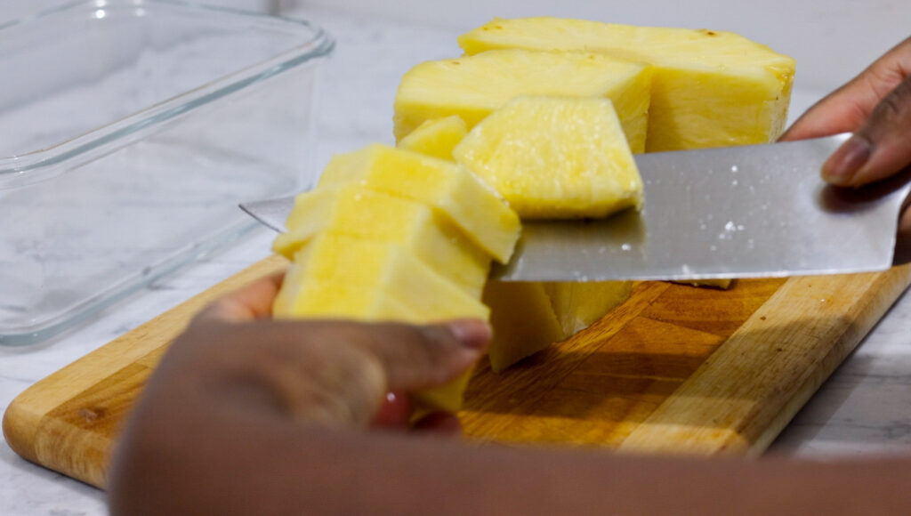 In this picture you can see a flight pineapple being cut into spears